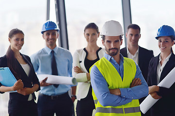 Image showing business people and construction engineers on meeting