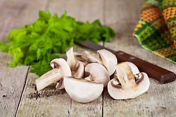 Image showing  fresh champignons, parsley and old knife
