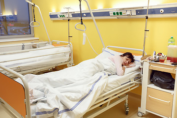 Image showing sad middle-aged woman lying in hospital