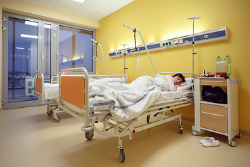 Image showing sad middle-aged woman lying in hospital