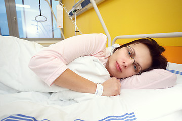 Image showing sad middle-aged woman lying in hospital