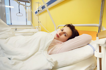 Image showing sad middle-aged woman lying in hospital