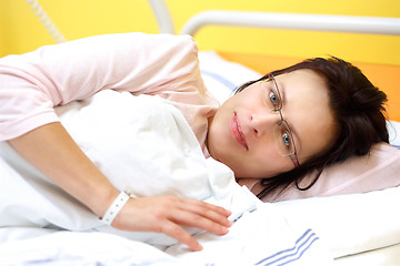 Image showing smiling middle-aged woman lying in hospital