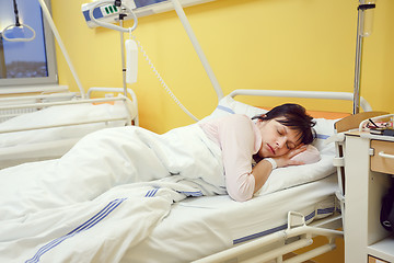 Image showing sad middle-aged woman lying in hospital