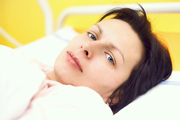 Image showing sad middle-aged woman lying in hospital