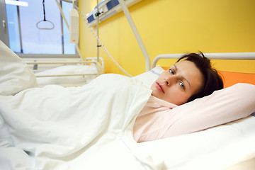 Image showing sad middle-aged woman lying in hospital