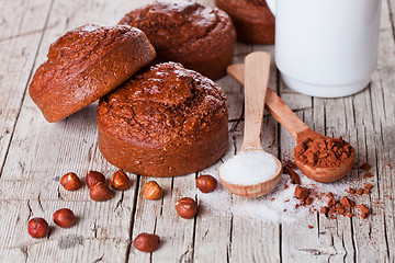 Image showing fresh baked browny cakes, milk, sugar, hazelnuts and cocoa powde