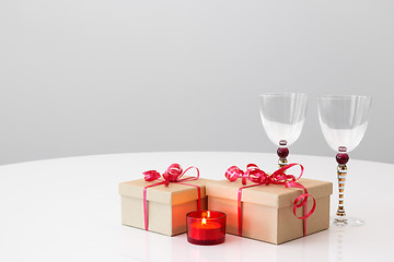 Image showing Gifts, wineglasses and candlelight