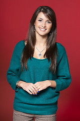 Image showing Young smiling brunette woman in warm clothes