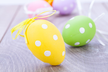 Image showing colorful easter egg decoration on wooden background