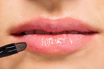 Image showing woman applying lipstick on lips natural beauty