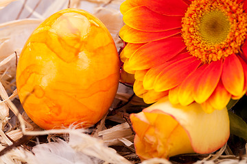 Image showing Vivid orange Easter egg with a gerbera and rose