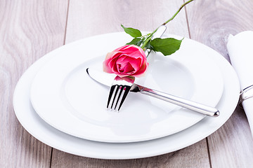 Image showing Table setting with a single pink rose