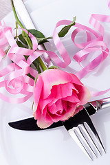 Image showing Table setting with a single pink rose