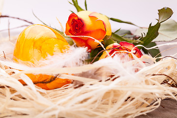 Image showing Vivid orange Easter egg with a gerbera and rose