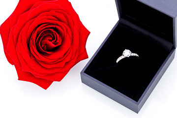 Image showing Engagement ring with a bunch of red roses