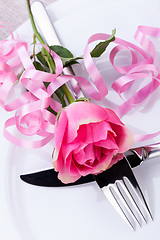 Image showing Table setting with a single pink rose