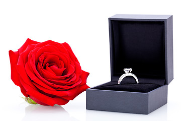 Image showing Engagement ring with a bunch of red roses