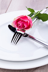 Image showing Table setting with a single pink rose