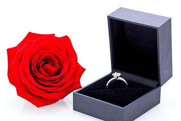 Image showing Engagement ring with a bunch of red roses