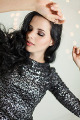 Image showing Beautiful dreamy woman with glitter dress dancing