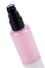 Image showing pink plastic bottle of cosmetic cream isolated on white