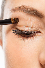 Image showing doing the makeup brown eyeshadow on beautiful eyes
