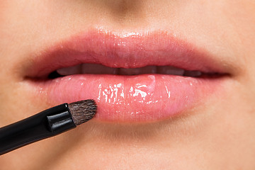 Image showing woman applying lipstick on lips natural beauty