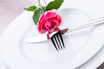 Image showing Table setting with a single pink rose