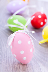 Image showing colorful easter egg decoration on wooden background