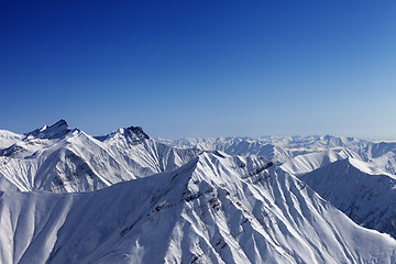 Image showing Snowy rocks in nice sun day, view from ski slope