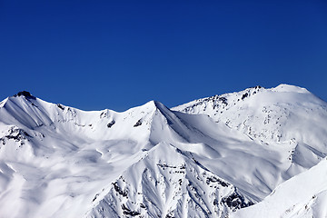 Image showing Off piste snowy slope and blue clear sky