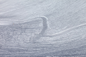 Image showing Off-piste slope and snowy road with trace from ski and snowboard