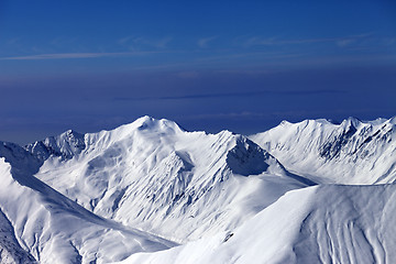 Image showing View on off-piste slopes and multicolor blue sky at nice sunny e