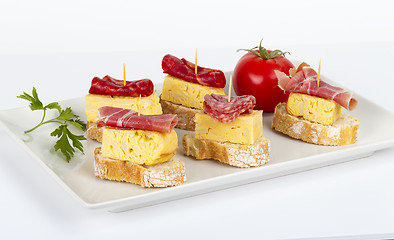 Image showing thin slices of Iberian sausage omelette with bread