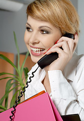 Image showing office lady with folders making a phone call