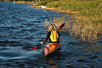 Image showing Blond girl on a kayak on a lake in Denmark