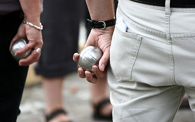 Image showing Petanque players arms
