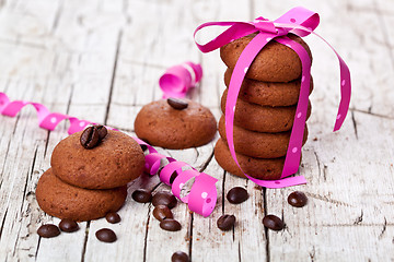 Image showing stack of chocolate cookies tied with pink ribbon and coffee bean