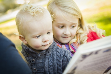 Image showing Mother Reading a Book to Her Two Adorable Blonde Children
