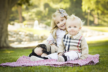 Image showing Sweet Little Girl with Her Baby Brother at the Park
