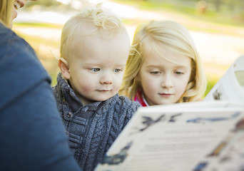 Image showing Mother Reading a Book to Her Two Adorable Blonde Children
