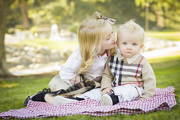 Image showing Sweet Little Girl Kisses Her Baby Brother at the Park
