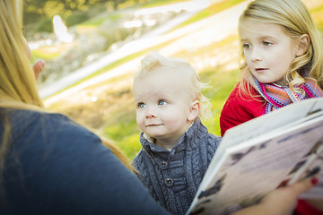 Image showing Mother Reading a Book to Her Two Adorable Blonde Children
