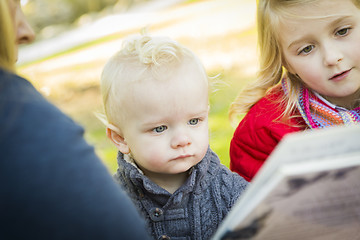 Image showing Mother Reading a Book to Her Two Adorable Blonde Children
