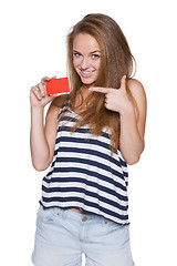 Image showing Excited girl teenager hipster pointing to the blank credit card