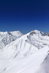 Image showing Off-piste slope and blue clear sky in sun day