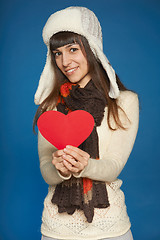 Image showing Winter woman in warm clothing giving heart shape