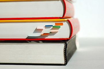 Image showing Three piled books