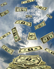 Image showing dollars flying away to the heaven